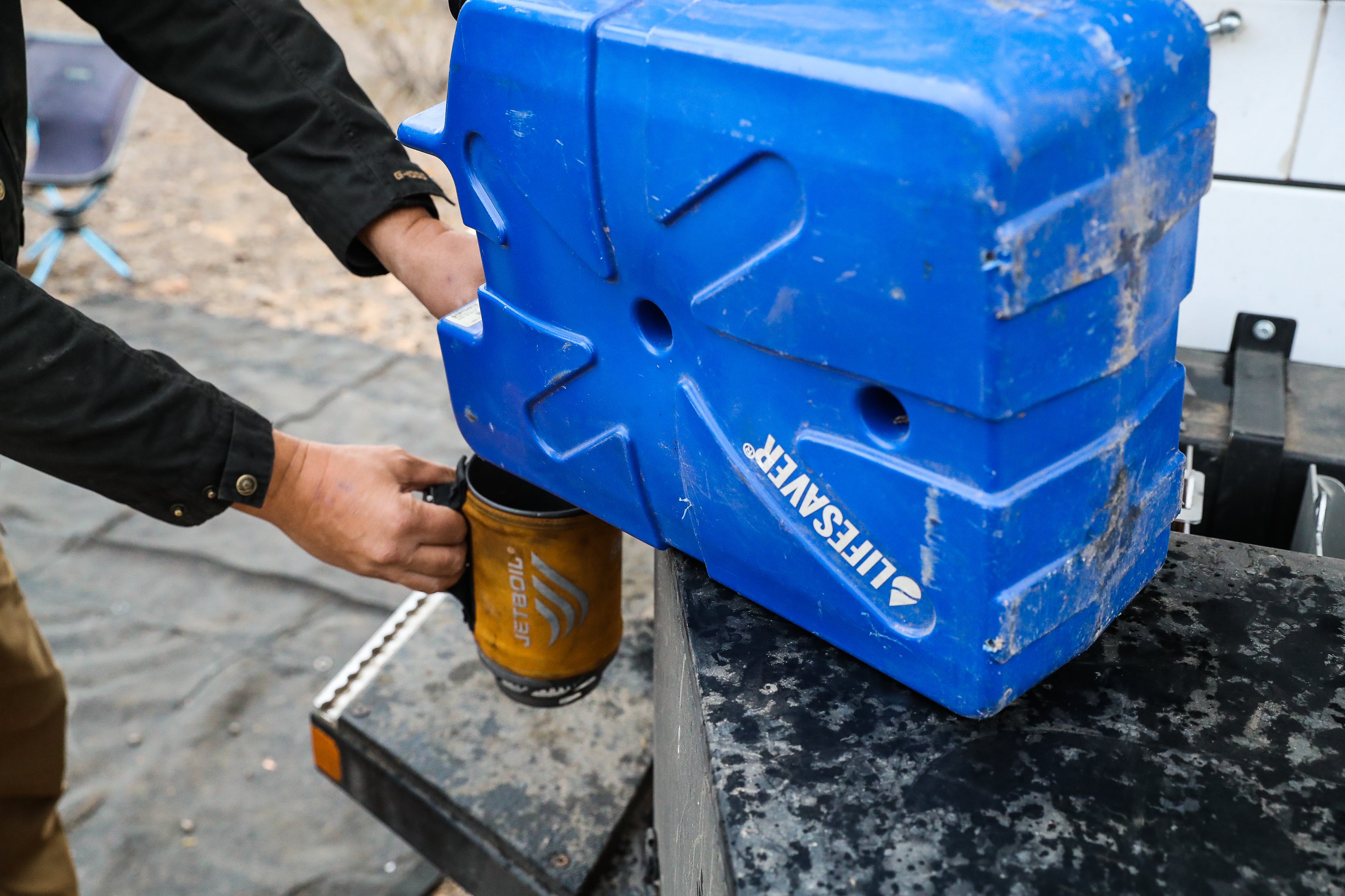Blue LifeSaver Jerrycan being used to fill a yellow mug.