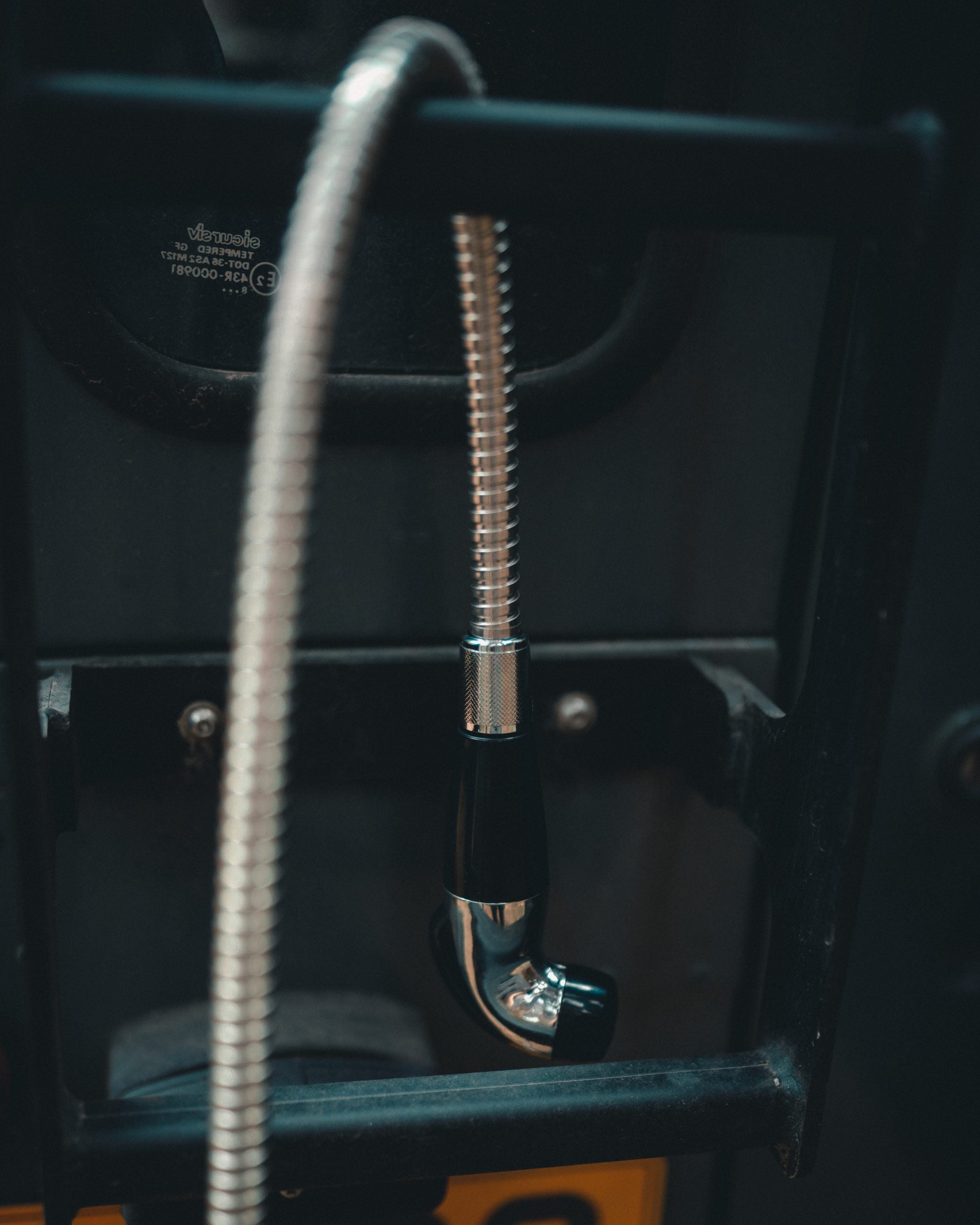 Jerrycan shower hose hanging off the back of a landrover
