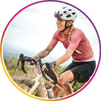 Woman riding a mountain bike on a trail with a scenic background