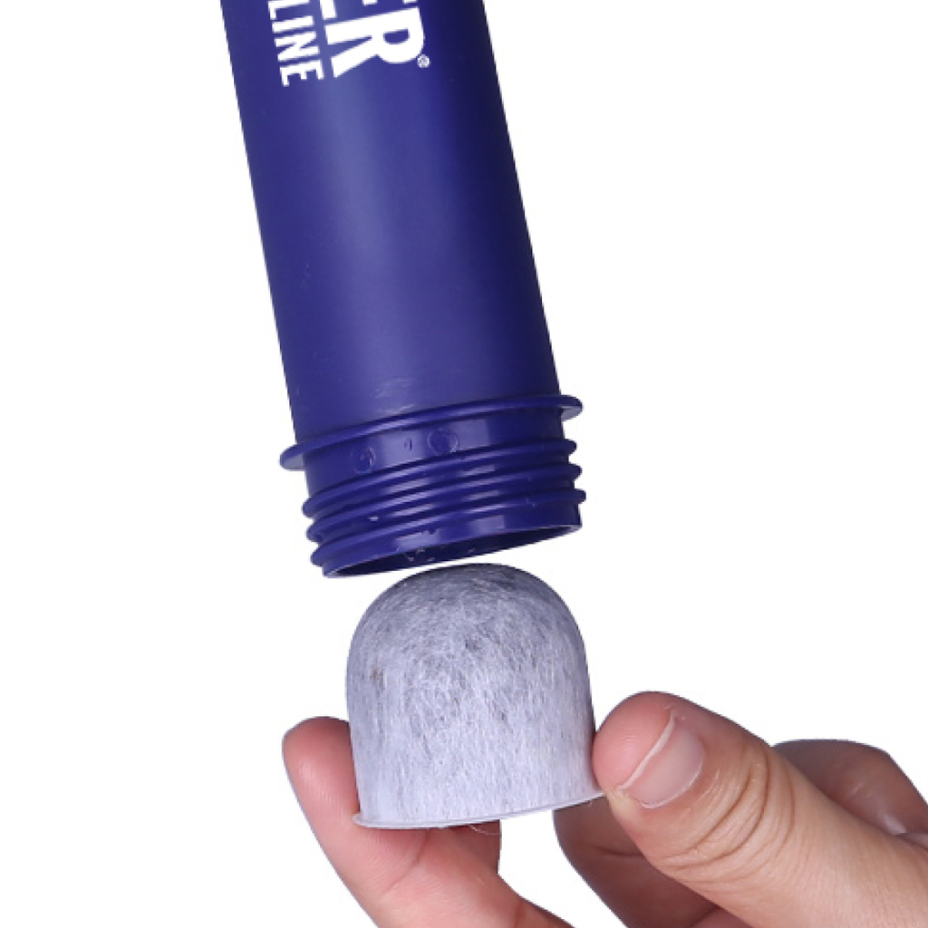 LifeSaver Lifeline activated carbon filter being inserted into the base of a Lifeline filter