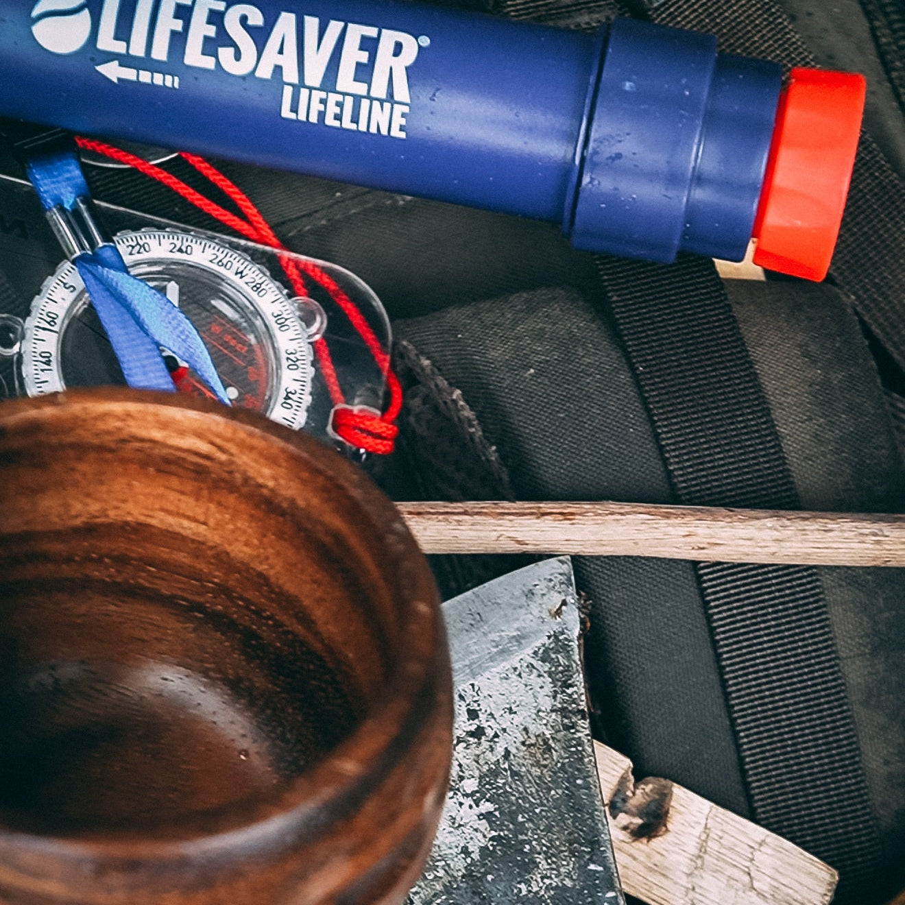 Lifesaver Lifeline water filter on a camping gear background